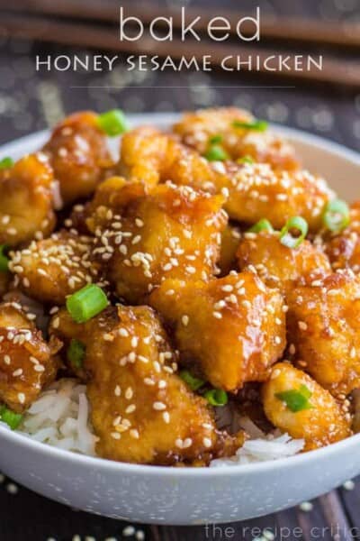 Delicious restaurant quality sweet and sour chicken that is baked to perfection! Baked Honey Sesame Chicken over white rice in a white bowl.