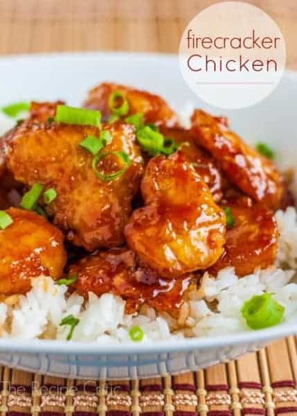 Delicious restaurant quality sweet and sour chicken that is baked to perfection! Firecracker Chicken over white rice on a white bowl.