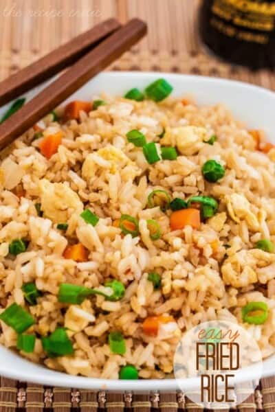 Delicious restaurant quality sweet and sour chicken that is baked to perfection! Easy Fried Rice in a white bowl.