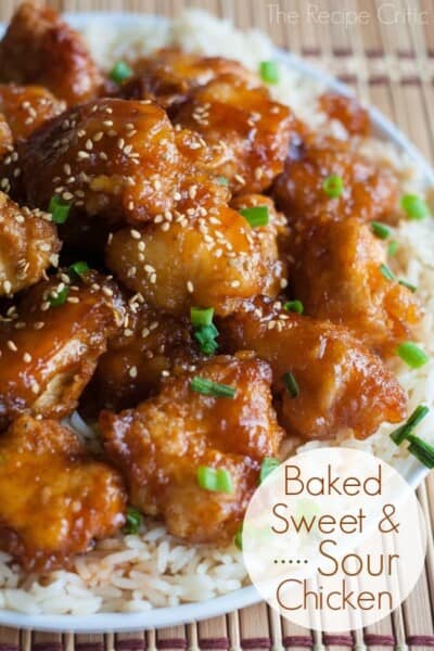 Delicious restaurant quality sweet and sour chicken that is baked to perfection! Baked Sweet and Sour Chicken over white rice on a white plate.