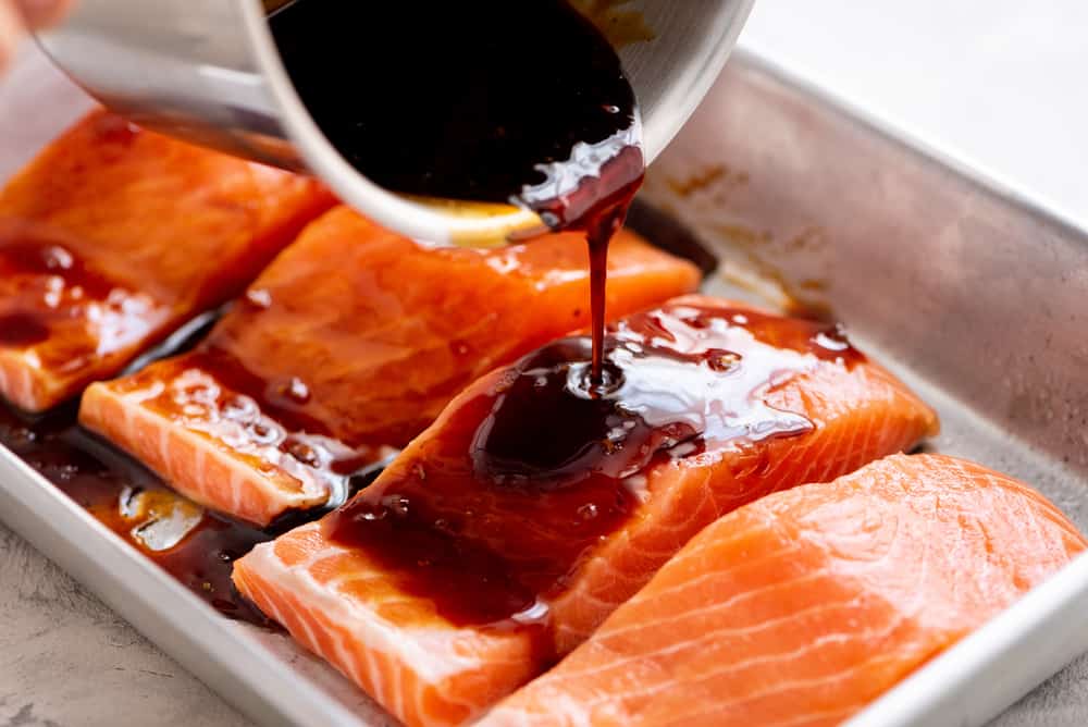 Baked Sesame Teriyaki Salmon is a five star salmon baked with the best homemade sesame teriyaki sauce. This is easily one of the best things that you will eat! salmon with teriyaki sauce drizzled over it
