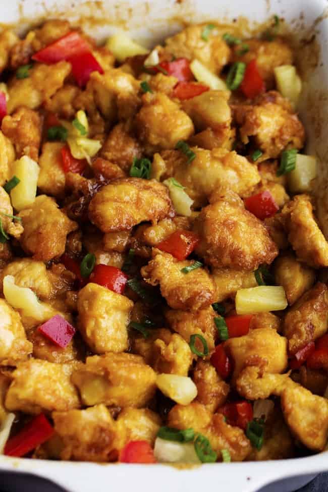 Delicious chicken that gets breaded and baked in a sweet and tangy pineapple sauce. It bakes to perfection and is so much better than takeout! baked hawaiian chicken in a pan.