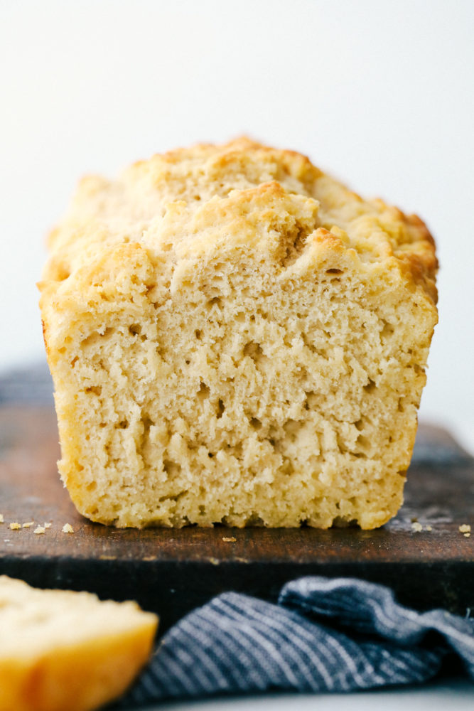 Beer bread sliced a piece off to see the thick and soft inside of the bread.