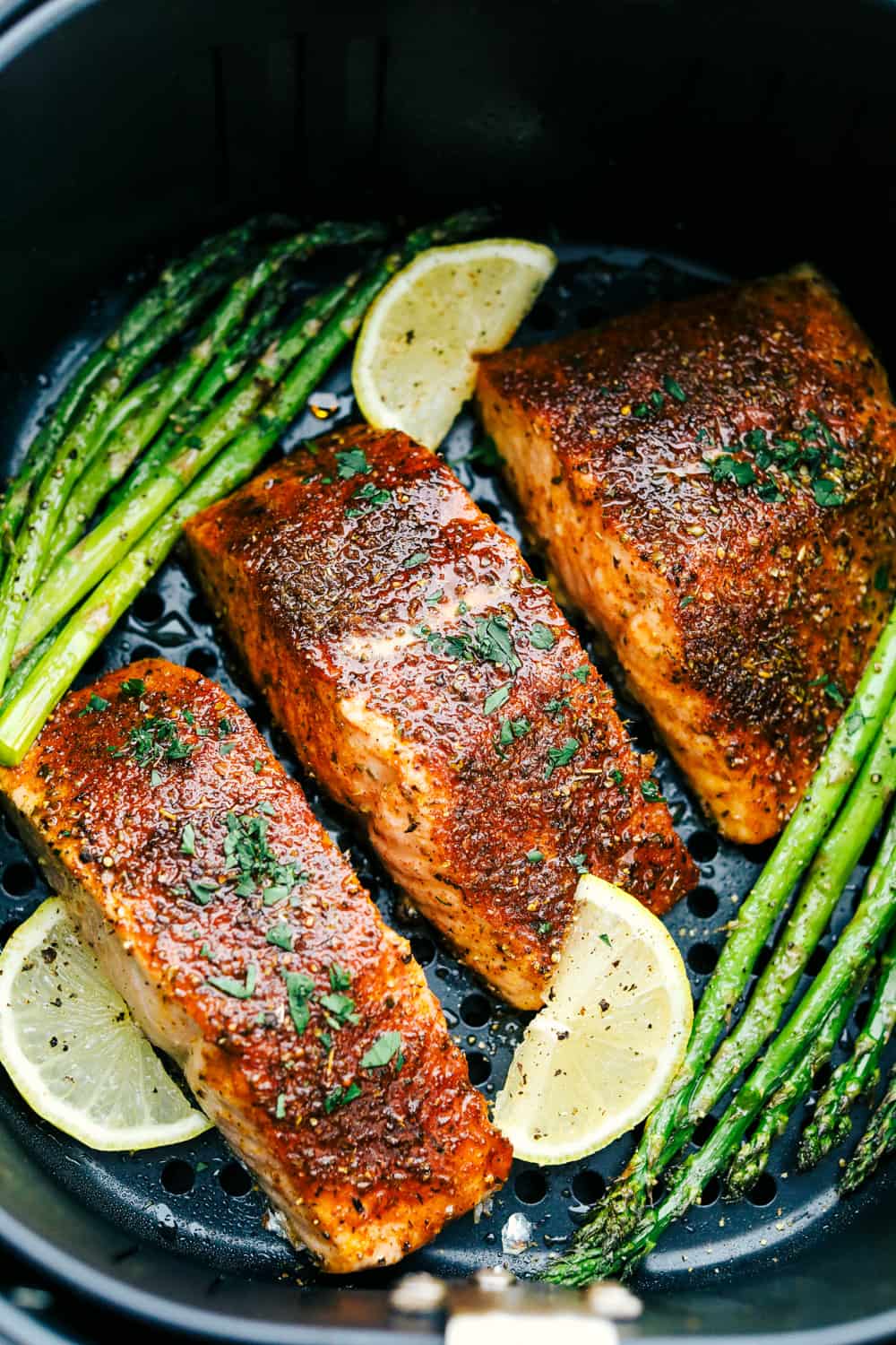 Melt-in-your-mouth brown sugar garlic air fryer salmon is juicy, tender and full of flavor. Salmon is so good, especially when it's cooked right, and the air fryer makes it perfect every time! It's an easy, hands-off way to make a scrumptious meal. Juicy, tender brown sugar garlic salmon served with asparagus and lemon wedges.