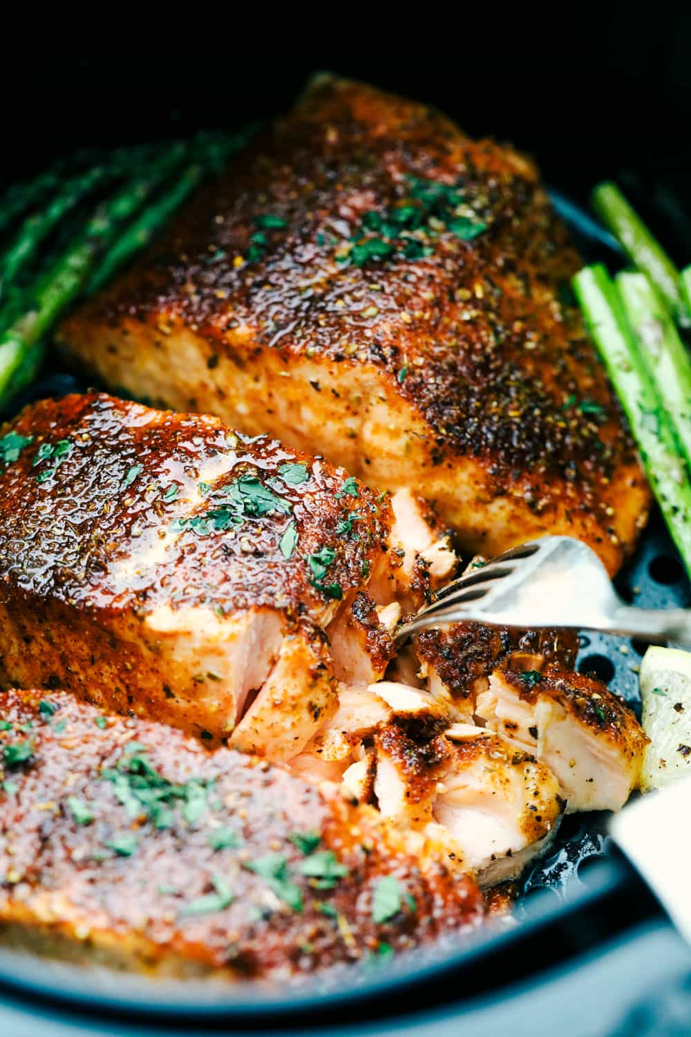Melt-in-your-mouth brown sugar garlic air fryer salmon is juicy, tender and full of flavor. Salmon is so good, especially when it's cooked right, and the air fryer makes it perfect every time! It's an easy, hands-off way to make a scrumptious meal. Closeup of tender, juicy Brown Sugar Garlic Salmon