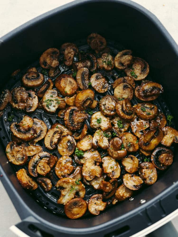 Confession: I never thought I liked mushrooms… until I made these air fryer mushrooms. With garlic parmesan, they’re juicy, tender, and downright addictive. Even the mushroom skeptics at your table will be fighting over the last bite! Air fryer mushrooms cooked in the bottom of the basket.